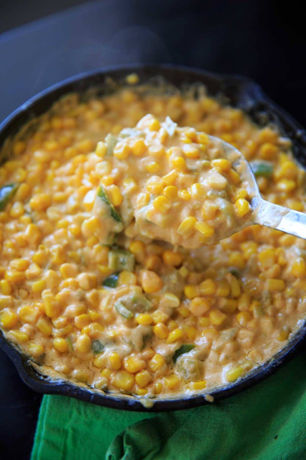 taking a big spoonful from the spicy hot corn dip