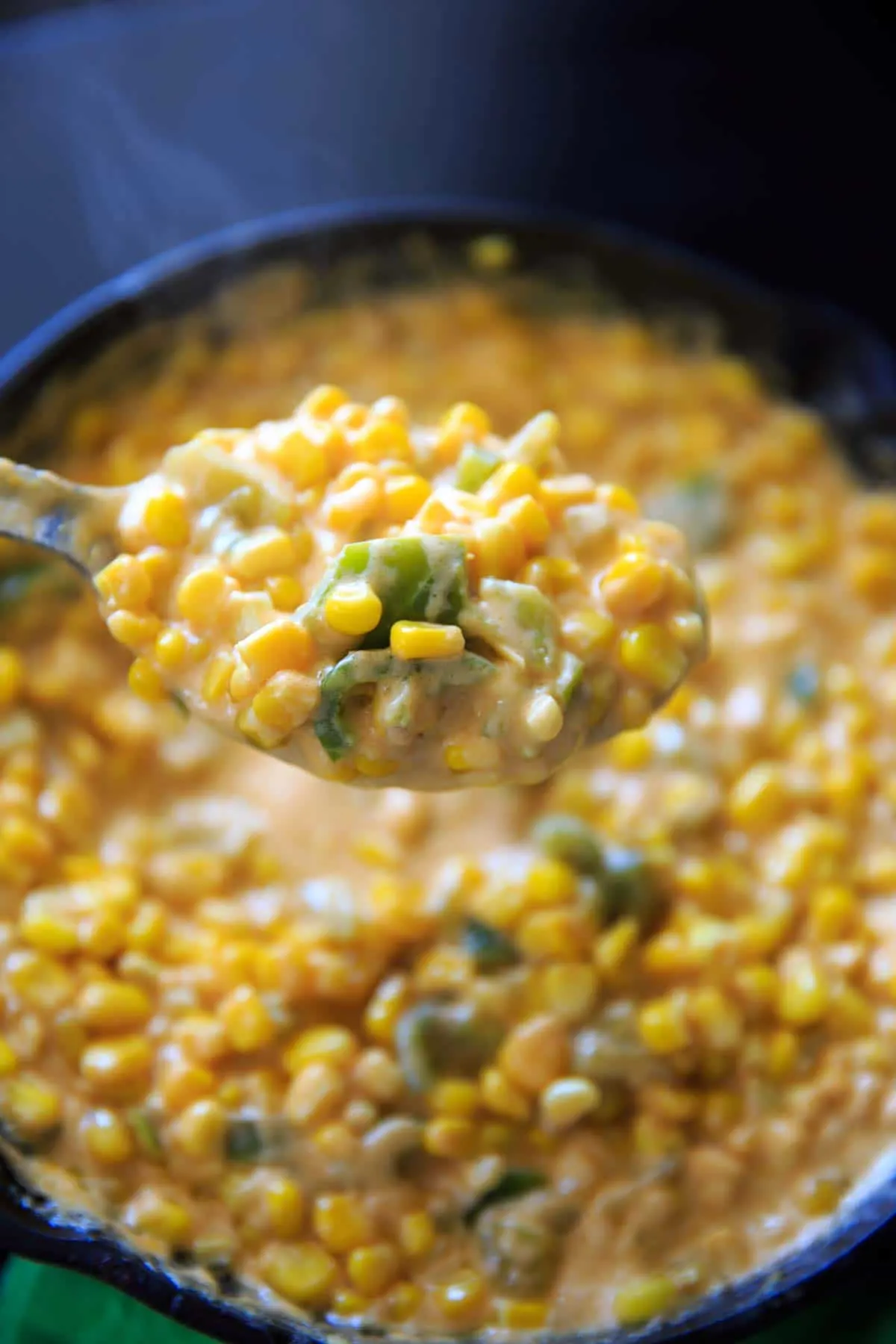closeup of spoonful of hot corn dip