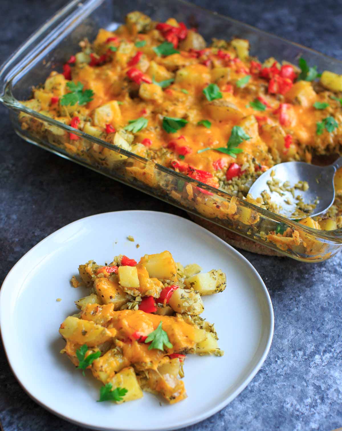 Broccoli and cheese baked potato casserole with parsley, with one plated serving