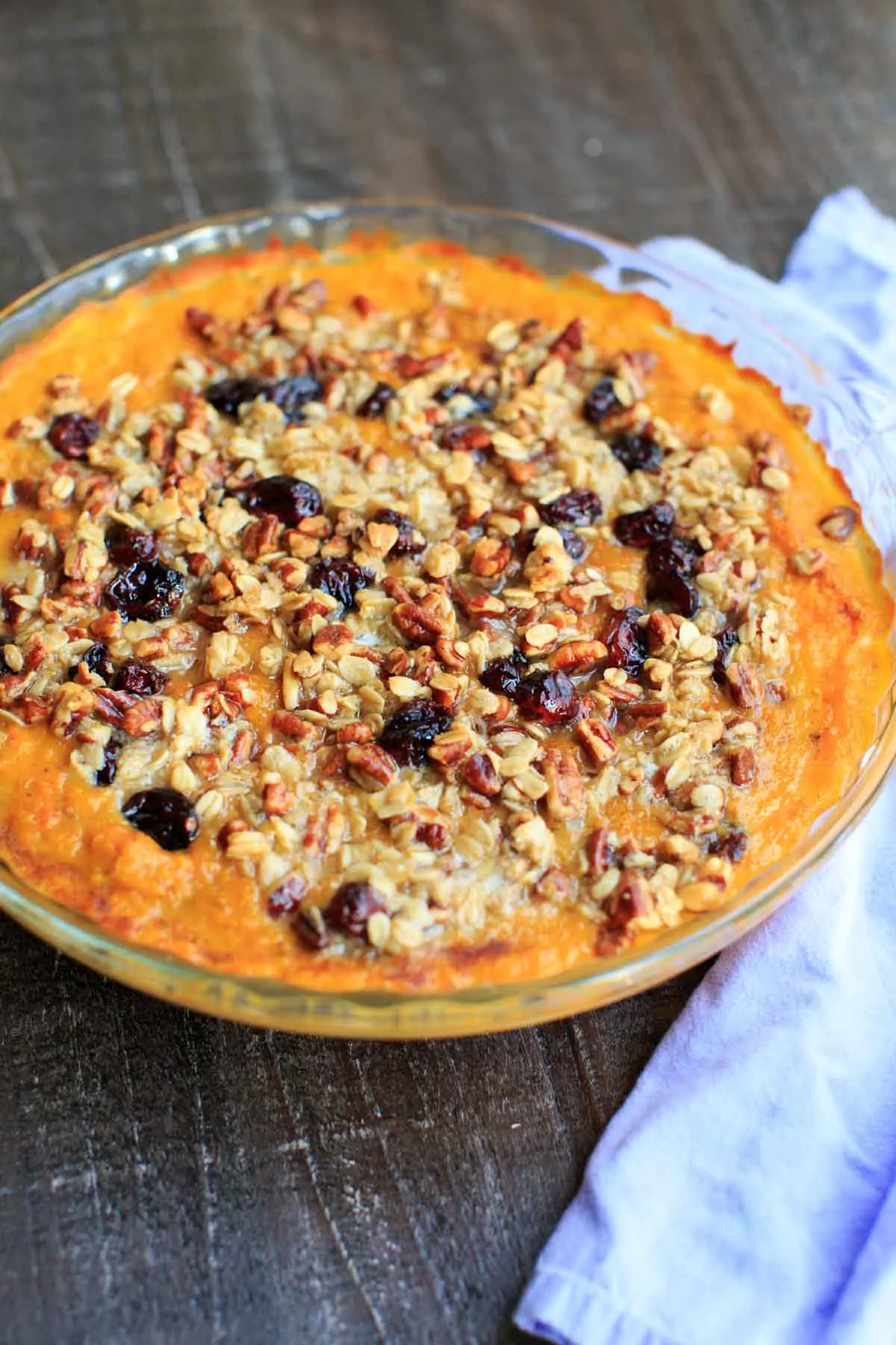 Sweet potato casserole with an oat, pecan and cranberries topping and sweetened with maple syrup. No sugar added!