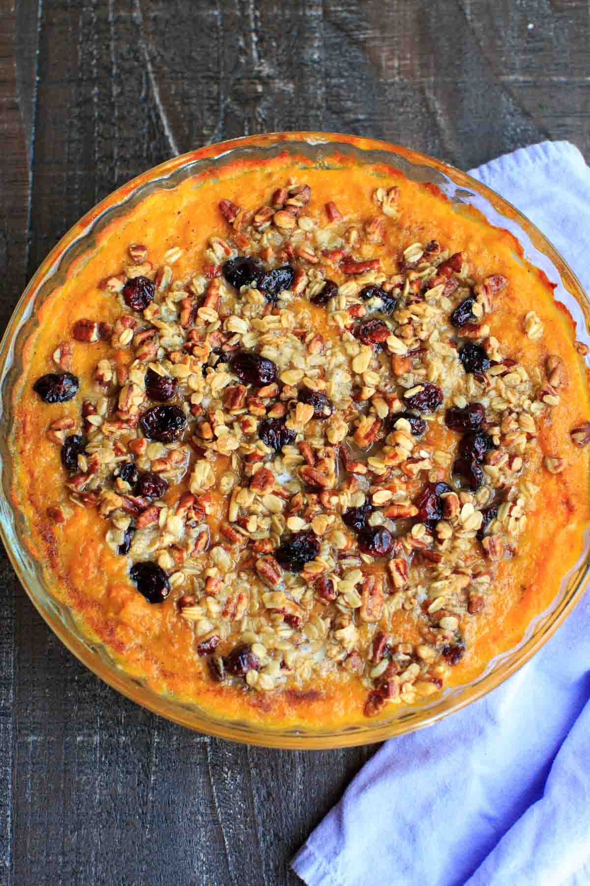 Sweet potato casserole with an oat, pecan and cranberries topping and sweetened with maple syrup. No sugar added!