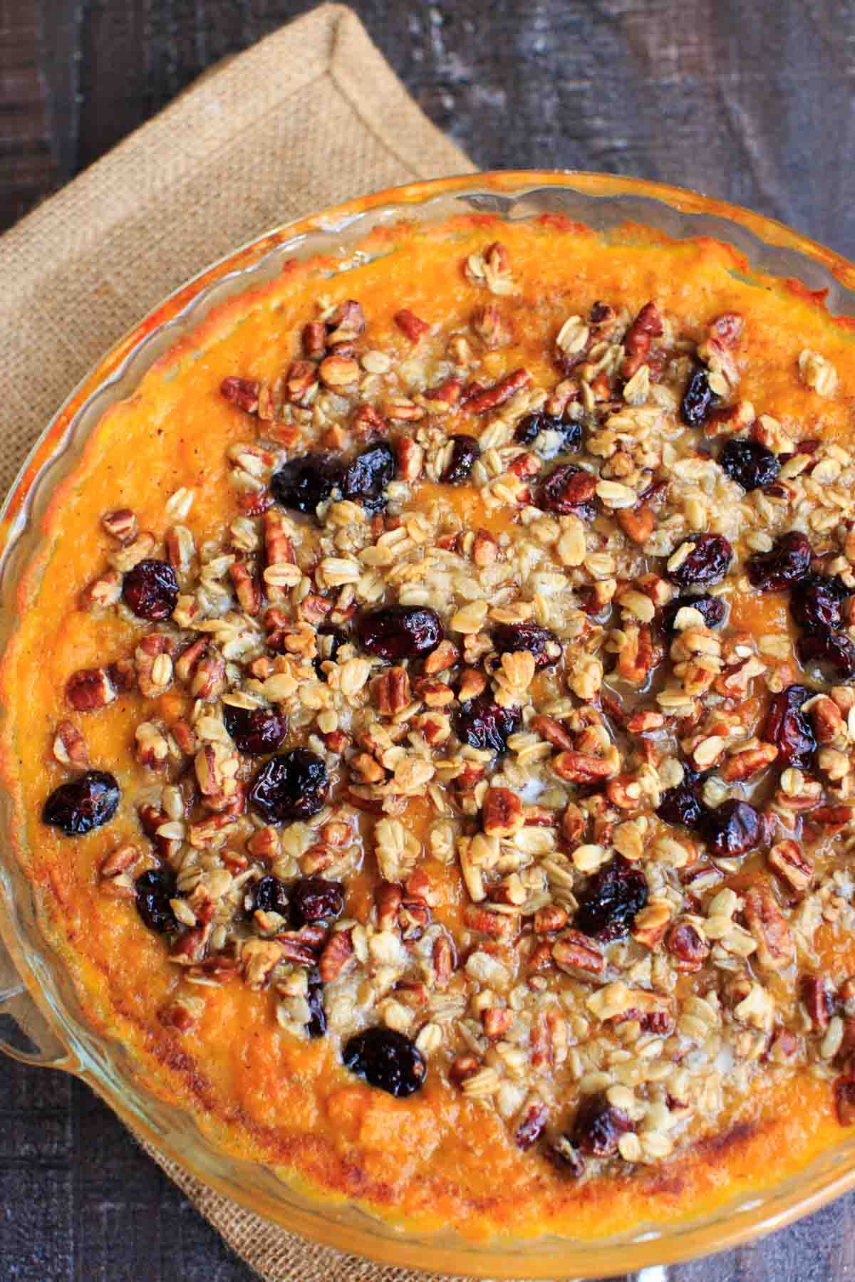 Sweet potato casserole with an oat, pecan and cranberries topping and sweetened with maple syrup. No sugar added!