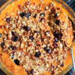 Sweet potato casserole with an oat, pecan and cranberries topping and sweetened with maple syrup. No sugar added!