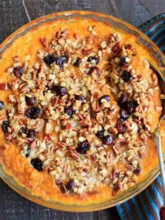 Sweet potato casserole with an oat, pecan and cranberries topping and sweetened with maple syrup. No sugar added!