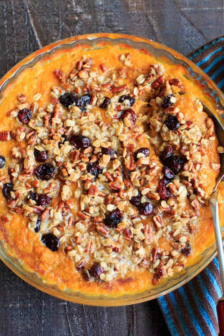 Sweet potato casserole with an oat, pecan and cranberries topping and sweetened with maple syrup. No sugar added!