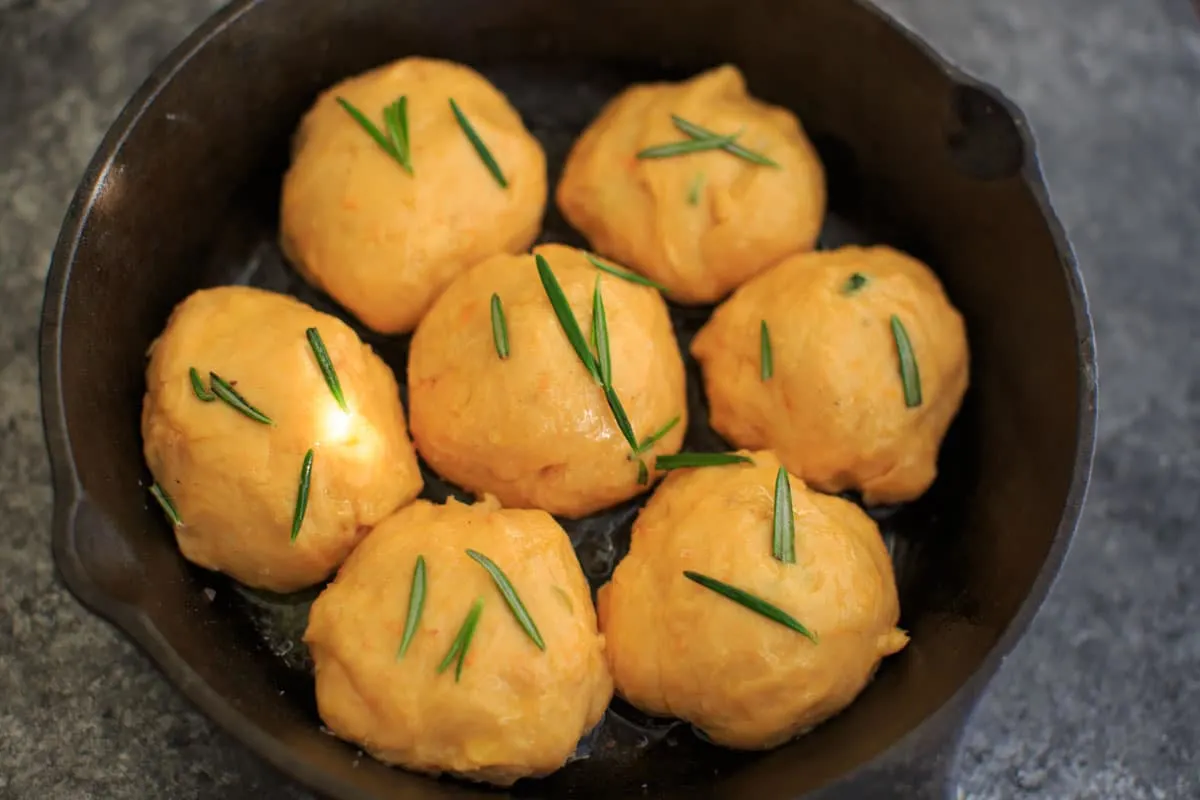 Rosemary Sweet Potato Dinner Rolls in cast iron before baking