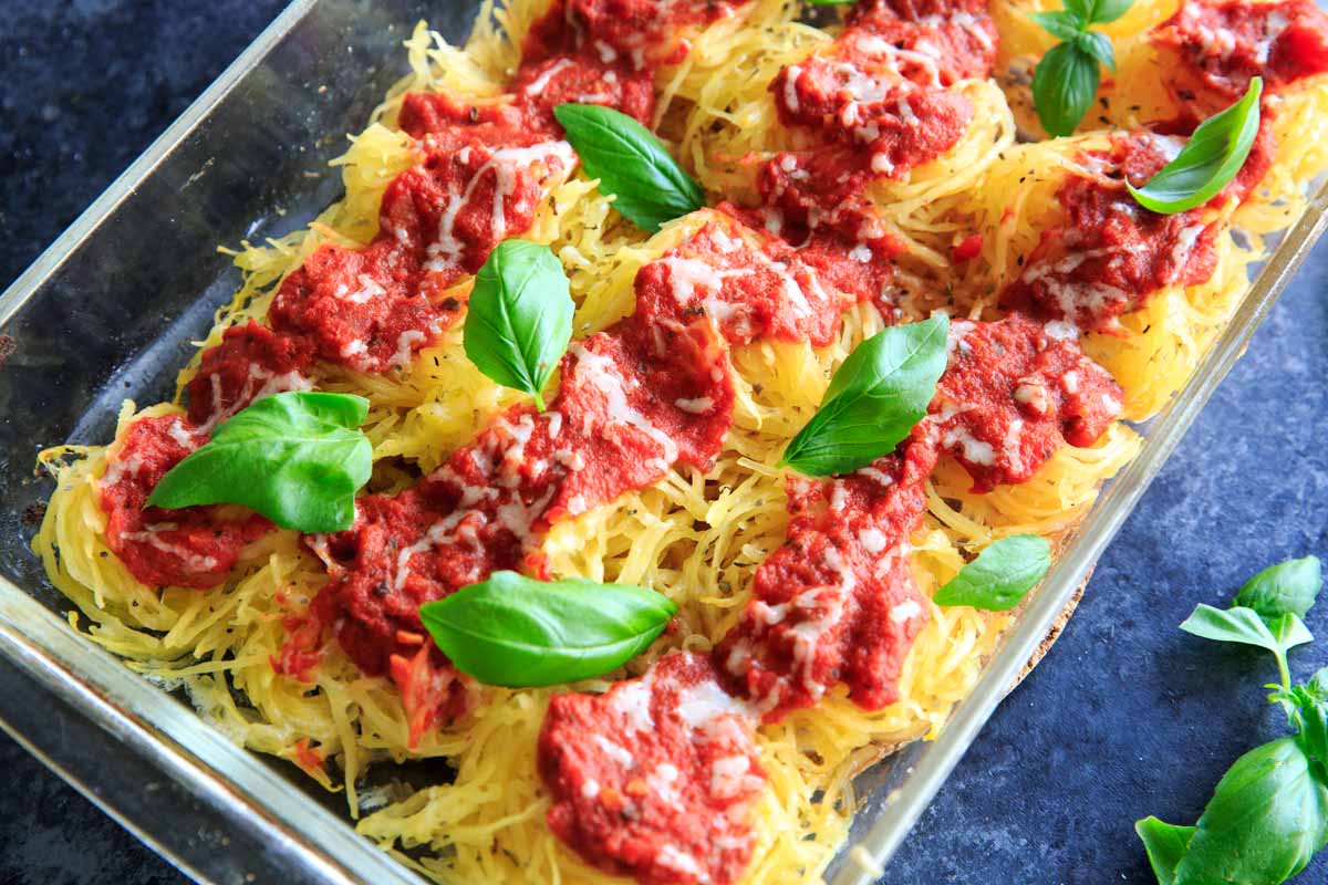 Spaghetti Squash Nests garnished with fresh basil are the perfect dinner appetizer for your guests. Customizable and delicious!