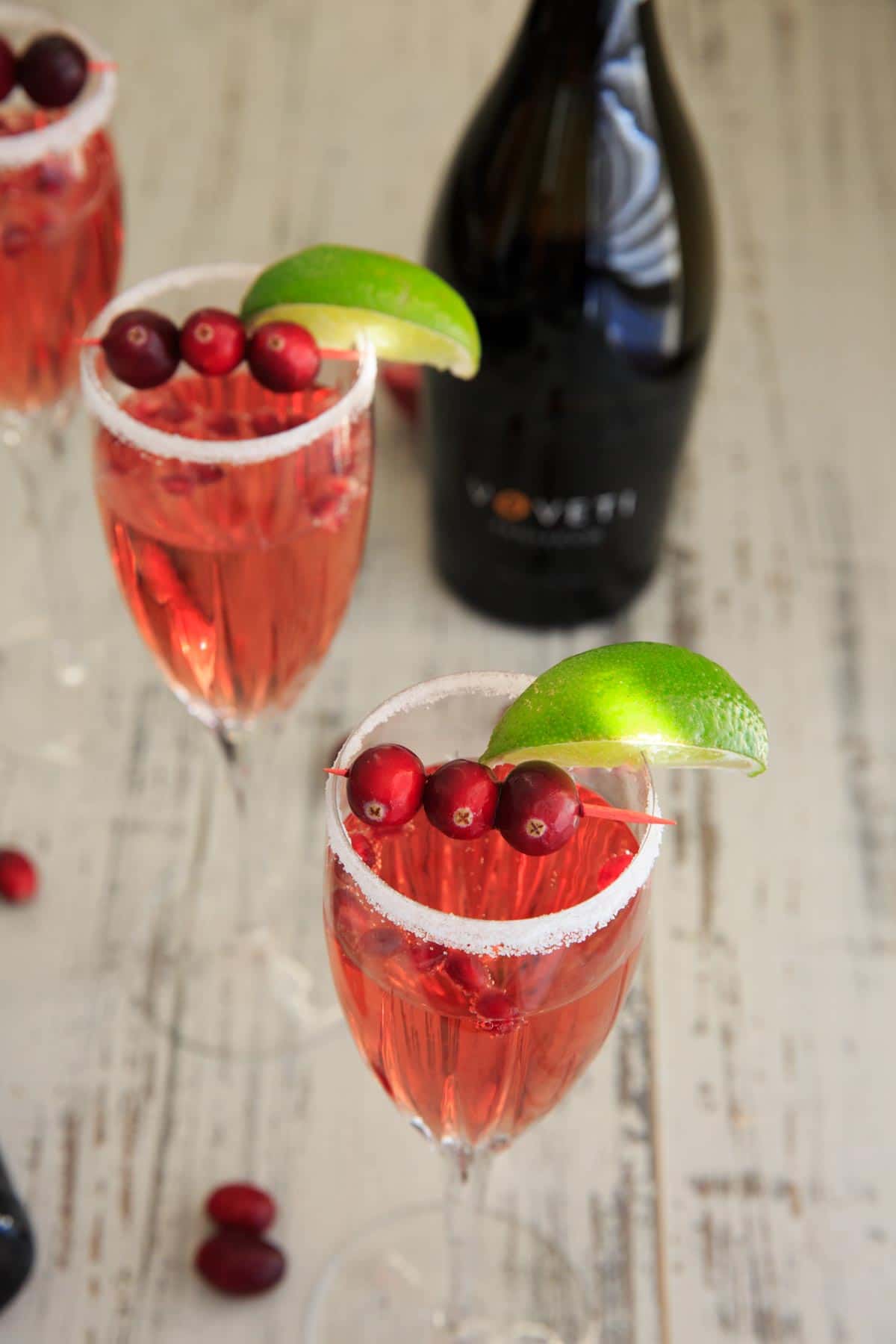 Cranberry Pomegranate Punch Cocktail with lime wedges