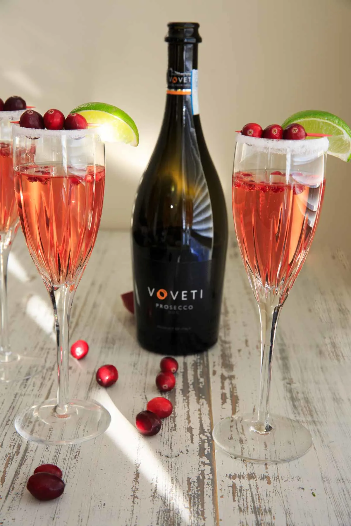 2 glasses of Cranberry Pomegranate Punch Cocktail with Voveti Prosecco bottle