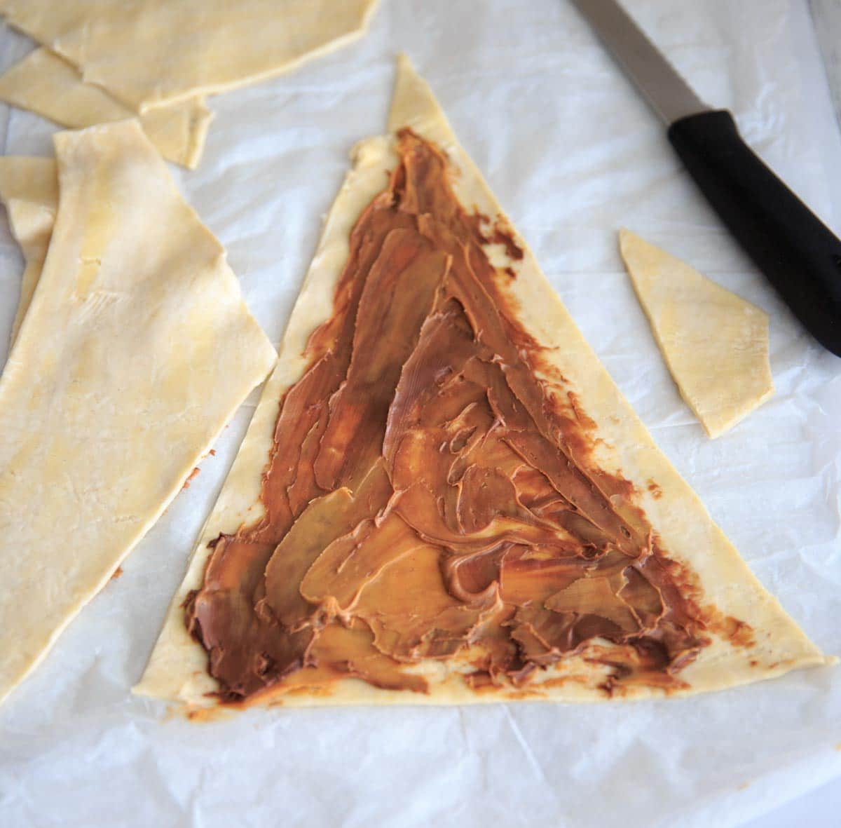 Add your filling - in this case, peanut butter and Nutella - to the puff pastry