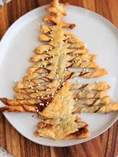 A Christmas-tree shaped dessert made with puff pastry, Nutella and peanut butter. Perfect for sharing at parties, super easy to make and only 3 ingredients. Top with powdered sugar or decorative sprinkles.