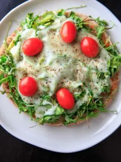 Quick and easy pita pizza recipe that you can make in the oven, microwave, or even on the grill! Fast lunch or dinner option that is completely customizable and faster than delivery.