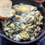 Arugula (or spinach) and artichoke brie dip, made in a cast iron skillet. A delicious and unique appetizer!