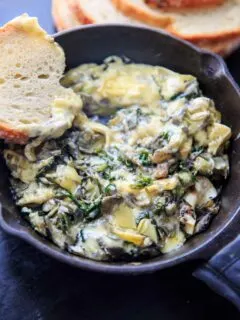 Arugula (or spinach) and artichoke brie dip, made in a cast iron skillet. A delicious and unique appetizer!