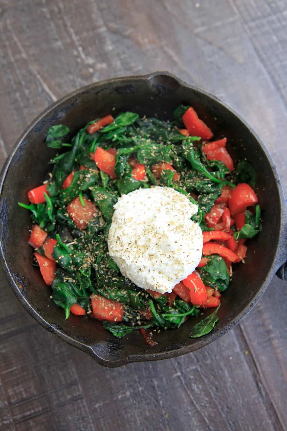 sauteed spinach and bell pepper with ricotta in cast iron pan - for the Spinach Ricotta Crescent Wrap recipe