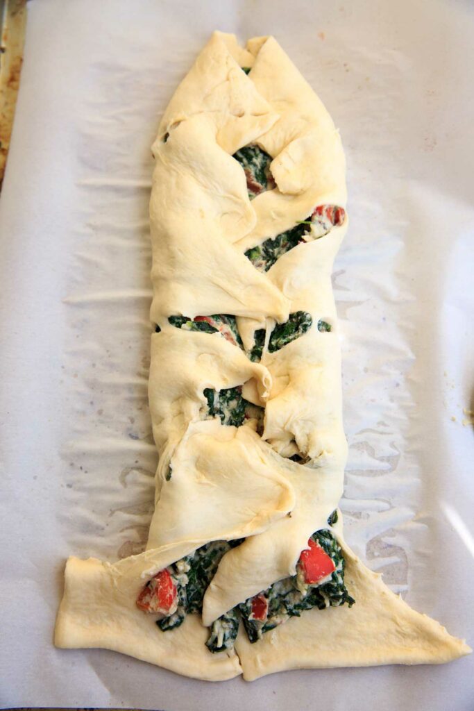 Braiding spinach ricotta mixture on crescent wrap - Spinach Ricotta Crescent Wrap