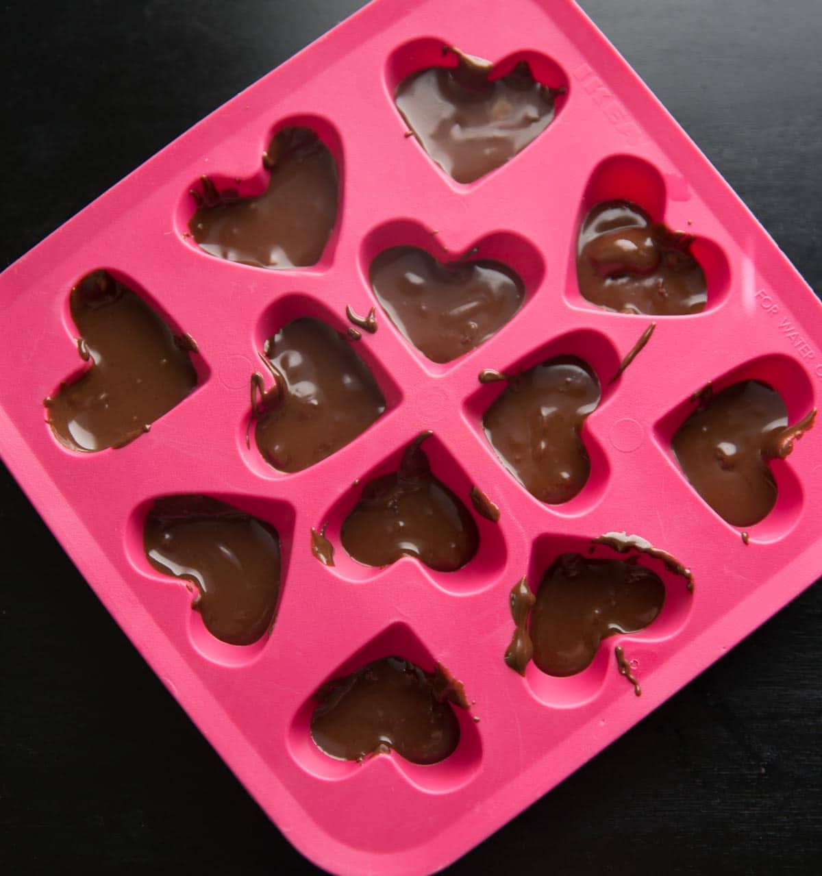 Chocolate Pomegranate Candy Recipe - melted chocolate in candy mold