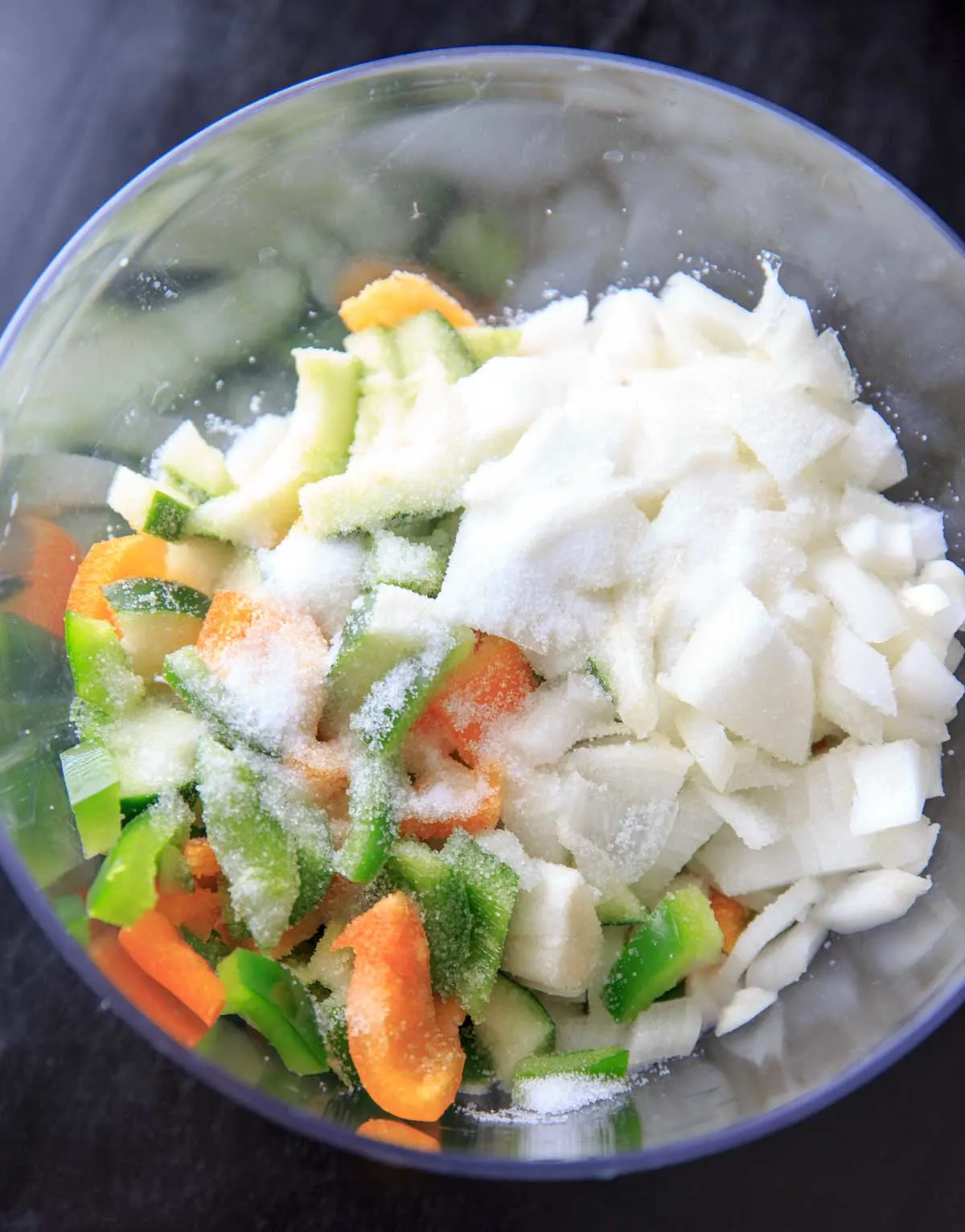  raw veggies with salt in bowl for making sweet pickle relish