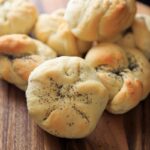 Homemade Kaiser Rolls Recipe - rolls after baking with poppy seeds horizontal