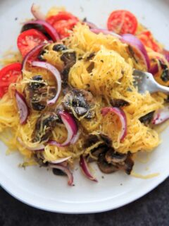 Spaghetti Squash with sauteed mushrooms, tomato and onion. A low-carb, gluten-free and vegan meal full of vegetables and flavor.