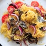 Spaghetti Squash with sauteed mushrooms, tomato and onion. A low-carb, gluten-free and vegan meal full of vegetables and flavor.