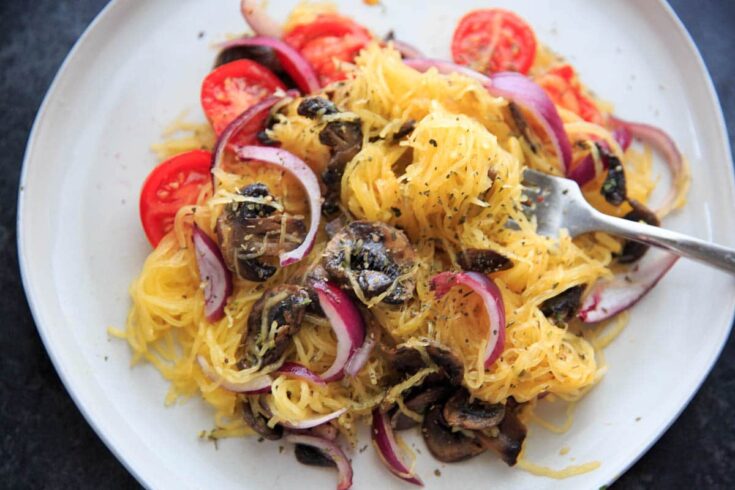 Spaghetti Squash with sauteed mushrooms, tomato and onion. A low-carb, gluten-free and vegan meal full of vegetables and flavor.