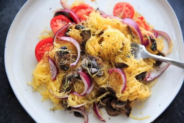 Spaghetti Squash with sauteed mushrooms, tomato and onion. A low-carb, gluten-free and vegan meal full of vegetables and flavor.