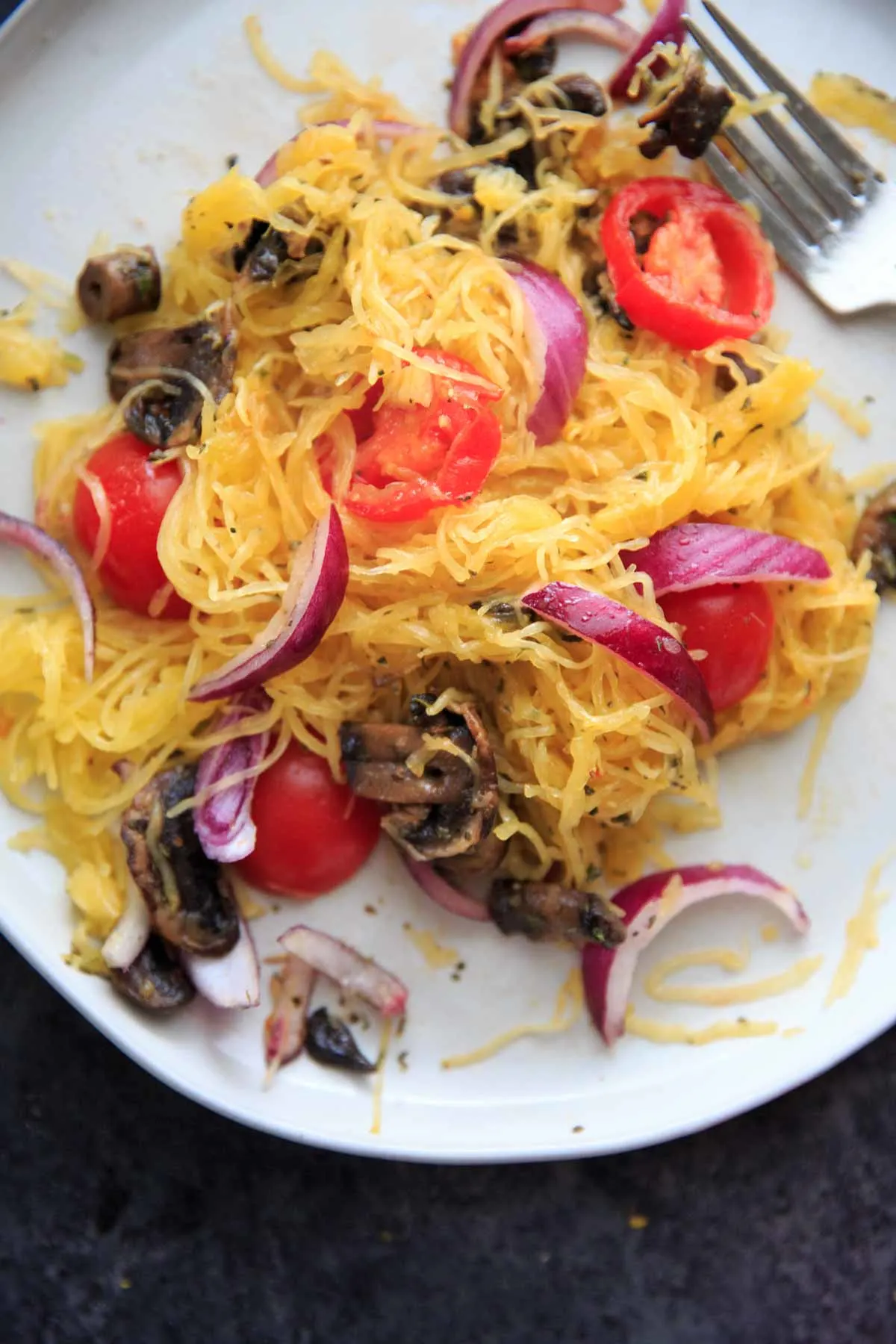 Spaghetti Squash with sauteed mushrooms, tomato and onion. A low-carb, gluten-free and vegan meal full of vegetables and flavor.