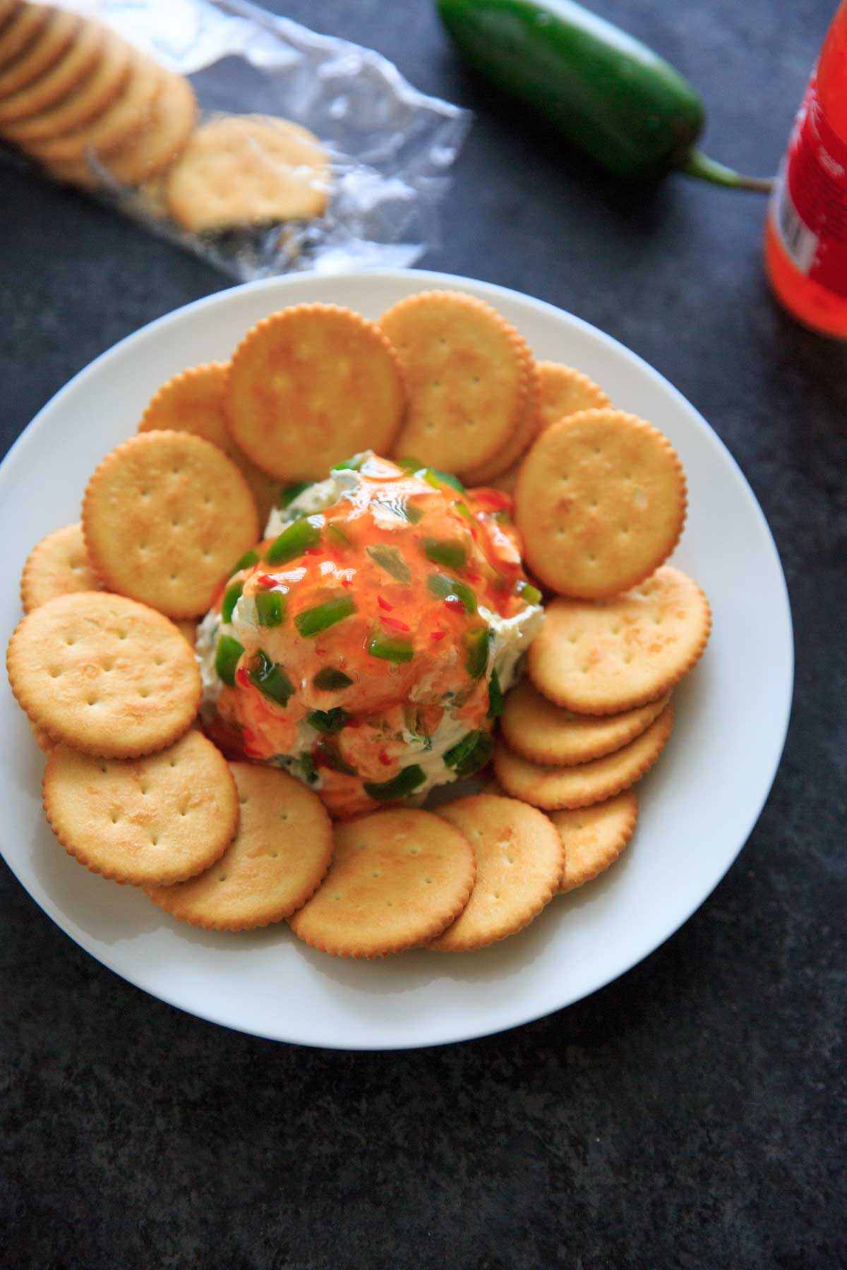Sweet Chili Cream Cheese Dip - a super easy, 4 ingredient appetizer that is perfect for a party snack or shareable dip. Sweet and spicy and delicious!