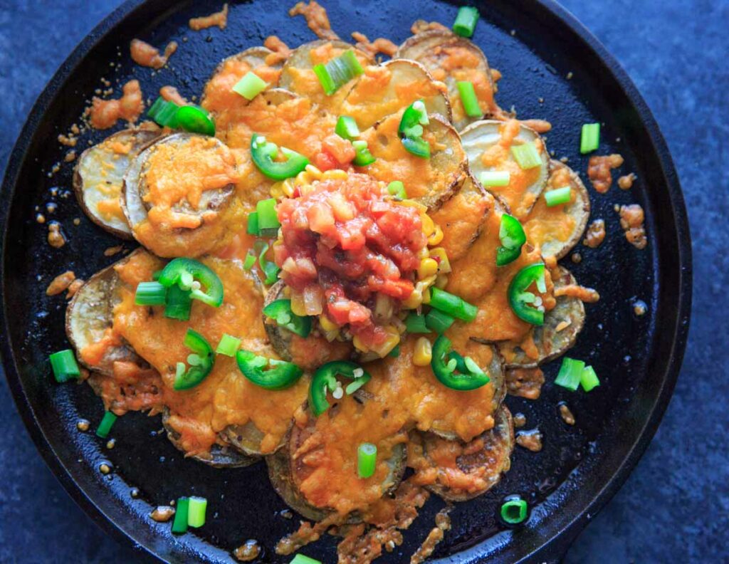 Irish Pub Potato Nachos Recipe - potato slices with cheddar cheese, jalapeno, green onion, corn salsa and tomato salsa (horizontal)