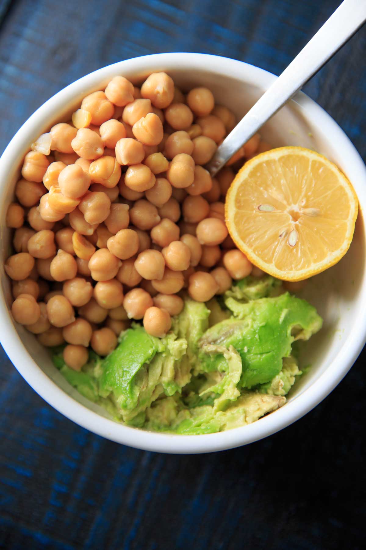 Smashed Avocado and Chickpea Salad Sandwich Recipe - chickpeas, avocado and lemon in a bowl