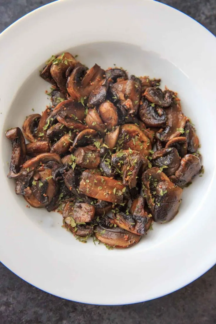 Chili White Button Mushrooms - sliced mushrooms caramelized in garlic and olive oil, topped with chili flakes and parsley. A deliciously easy, spicy and unexpected veggie side dish!