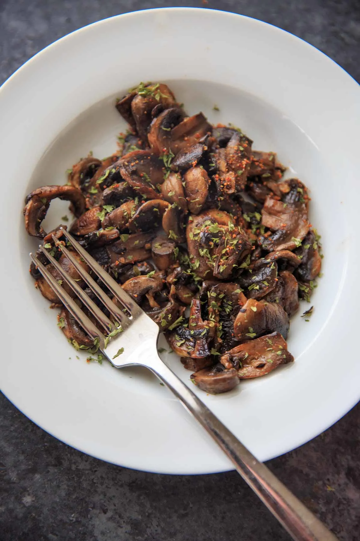 chili caramelized white button mushrooms in bowl with fork