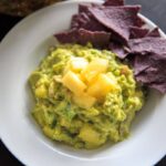 Pineapple Jalapeno Guacamole is a tropical spin on this favorite appetizer dip. Great for summer gatherings, cookouts and gatherings!