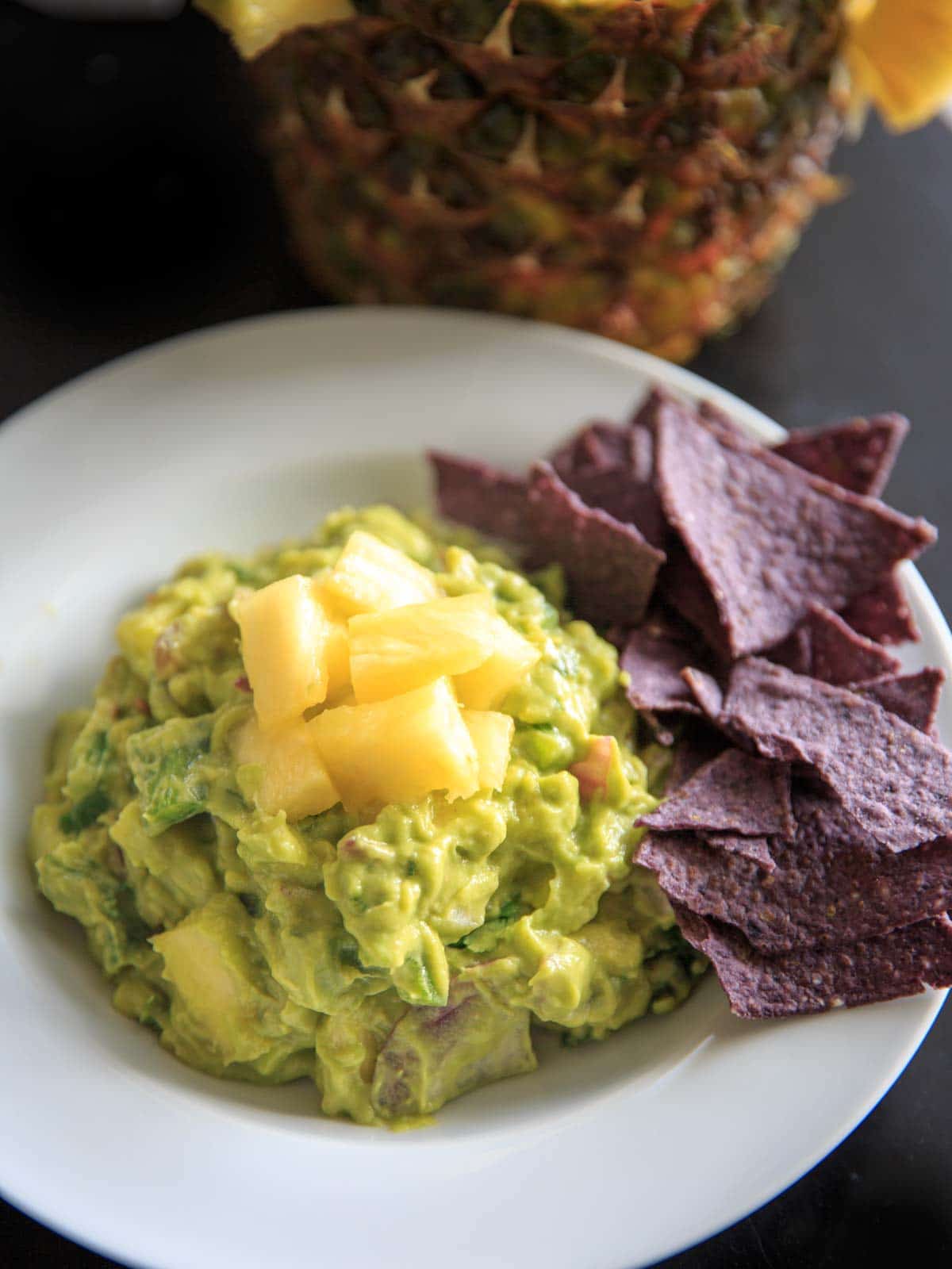 Pineapple Jalapeno Guacamole is a tropical spin on this favorite appetizer dip. Great for summer gatherings, cookouts and gatherings!