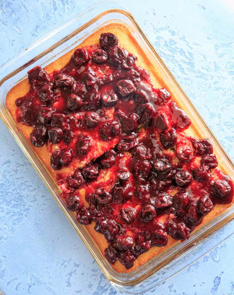 White Texas Sheet Cake with Cherry Glaze Topping. Perfect for a birthday cake or any cherry-lover, and those who don't like traditional frosting! Super easy recipe.