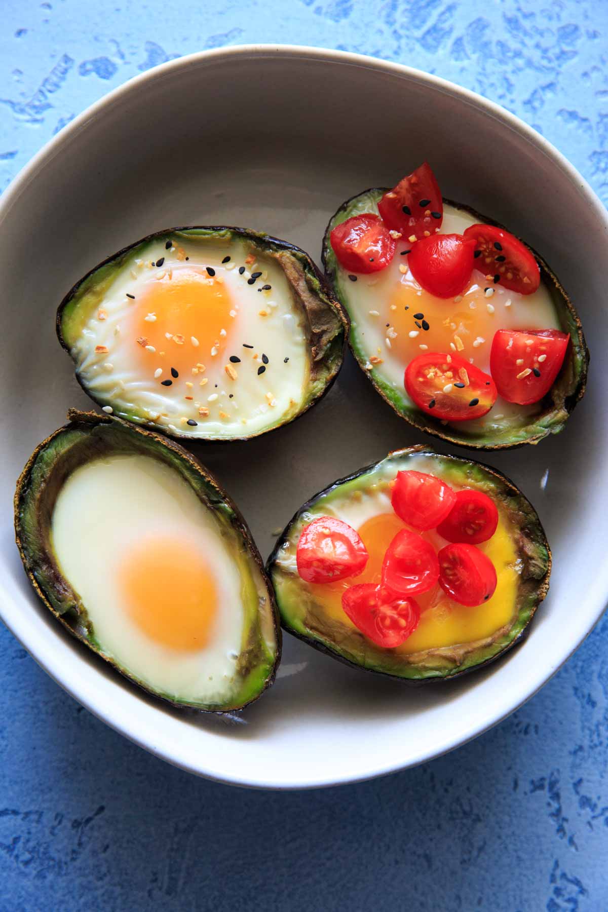 Baked Egg in Avocado's (Avocado "Nests") are a fun way to have a balanced snack or breakfast. Customizable with toppings and will last a day or two in the fridge, so you can bake ahead if needed! Low-carb, protein, fiber and healthy fats.