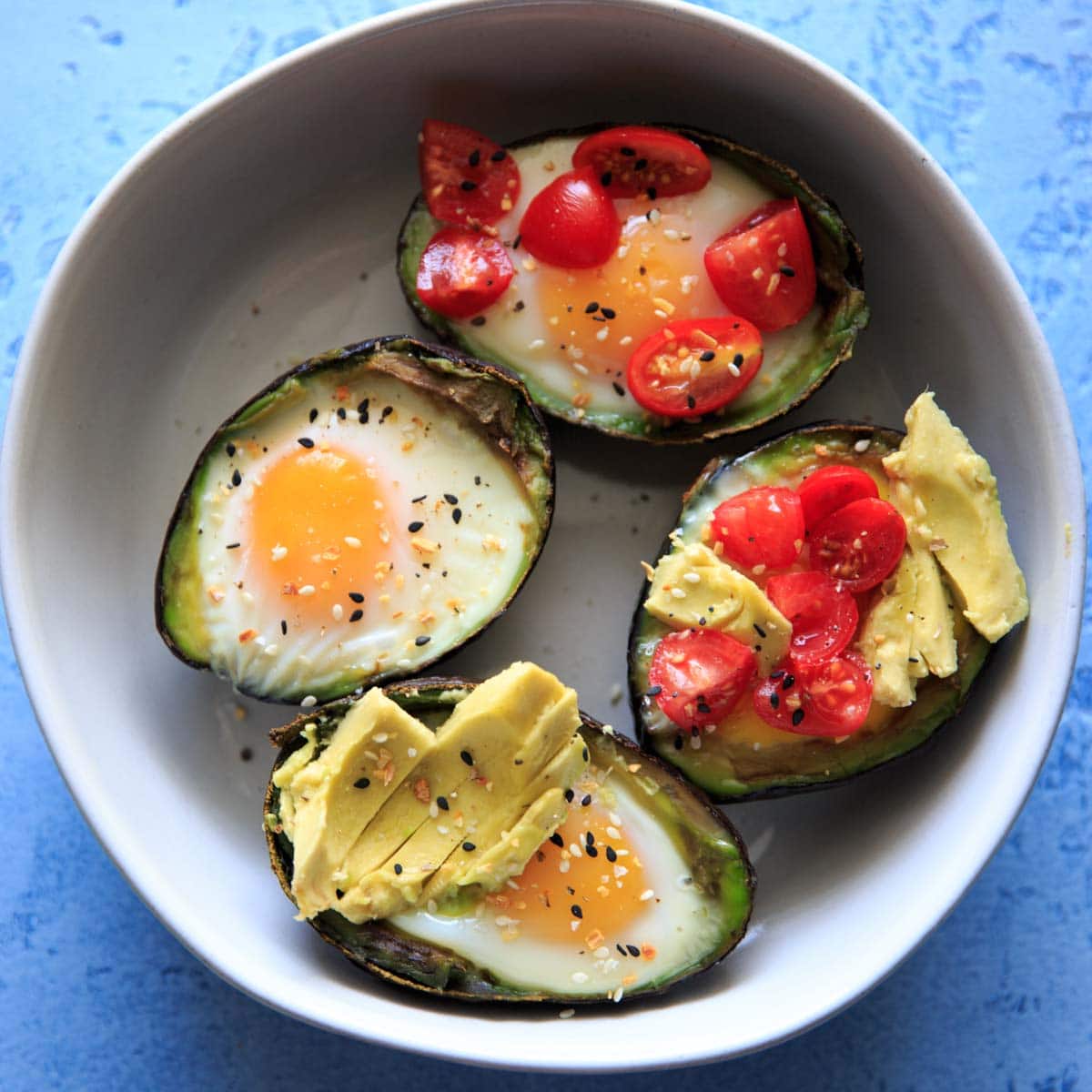 Baked Egg in Avocado's (Avocado "Nests") are a fun way to have a balanced snack or breakfast. Customizable with toppings and will last a day or two in the fridge, so you can bake ahead if needed! Low-carb, protein, fiber and healthy fats.