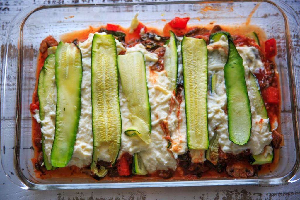 Layering the zucchini noodles on the lasagna
