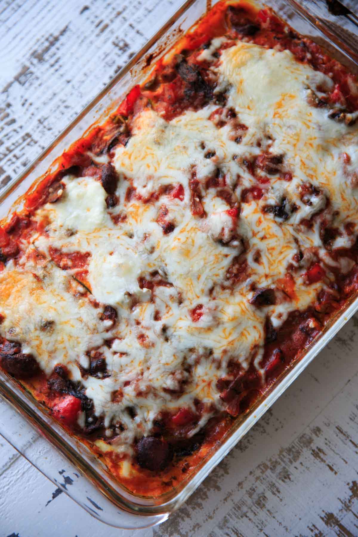 full casserole dish of zucchini lasagna topped with cheese after baking