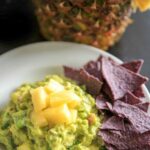 Pineapple Jalapeño Guacamole is a tropical spin on this favorite appetizer dip. Great for summer gatherings, cookouts and gatherings! Serve this vegan and gluten-free snack with corn chips, crackers or veggies.