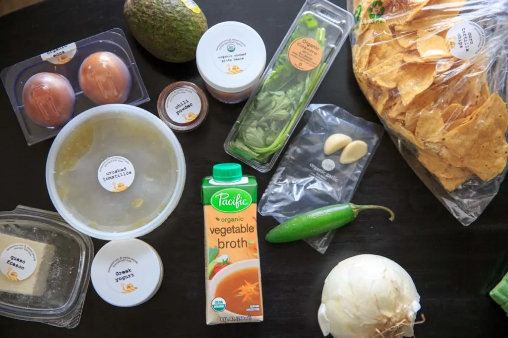 Ingredients for chilaquiles verdes with soft-scrambled eggs, avocado and queso fresco