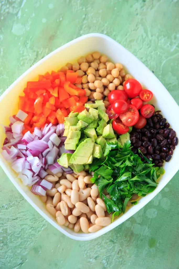 Three Bean Salad with avocado, vegetables and herbs - before mixing together