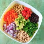 Three Bean Salad with avocado, vegetables and herbs. A flavorful vegan and gluten-free side dish perfect for a picnic or potluck, and filling enough for a main dish!