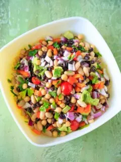 Three Bean Salad with avocado, vegetables and herbs. A flavorful vegan and gluten-free side dish perfect for a picnic or potluck, and filling enough for a main dish!