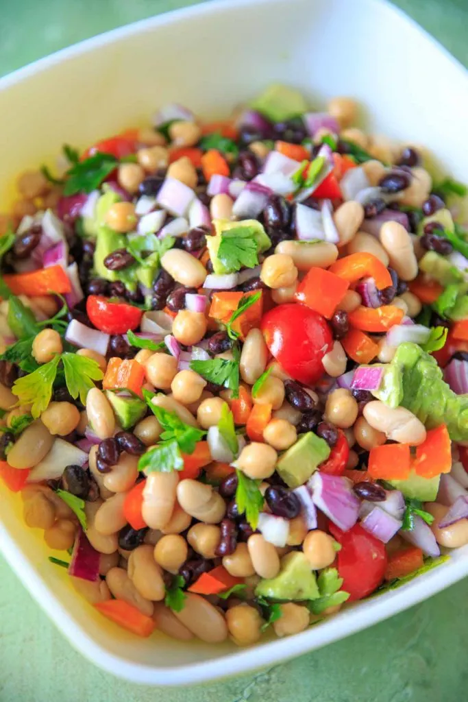 Three Bean Salad with avocado, vegetables and herbs close up