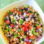 Three Bean Salad with avocado, vegetables and herbs. A flavorful vegan and gluten-free side dish perfect for a picnic or potluck, and filling enough for a meal!