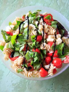 Caprese Pasta Salad - Tomatoes, basil, mozzarella, balsamic and olive oil on pasta