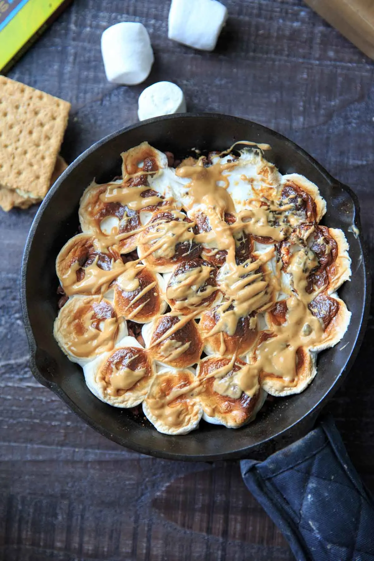 S'mores after baking in cast iron skillet with drizzled peanut butter on top