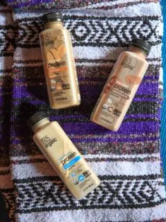 1915 Organic Protein Drink - Chocolate, Vanilla and Coffee on yoga mat and blanket